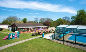 our-facilities Naturist facilities at the naturist foundation on a sunny day, with British naturists sitting around tables