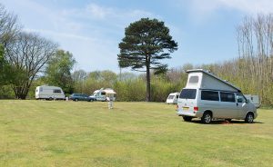 Naturist Campsite in the UK featuring open field and grass, caravans, where guests enjoy Naturist Camping, Naturist Glamping UK, at Brocken Hurst, The Naturist Foundation