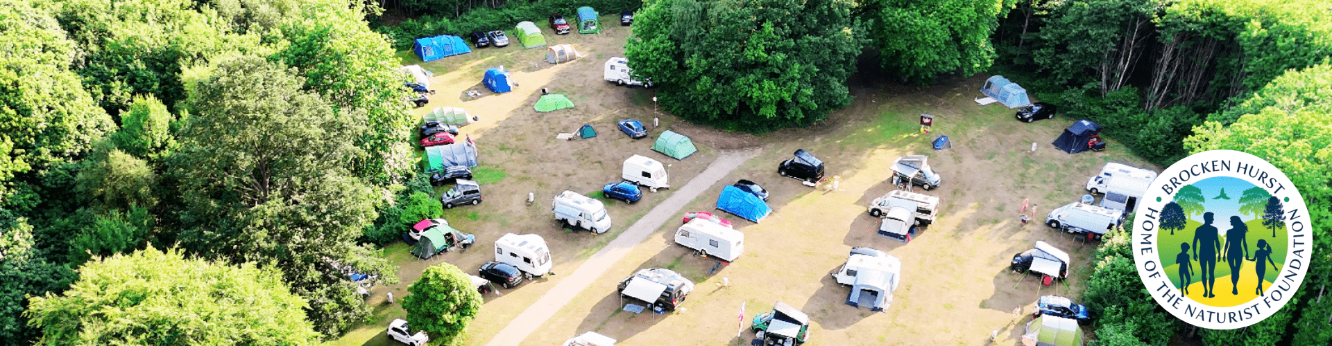 Nude camping campsite at Brocken Hurst with tents and caravans surrounded by forest